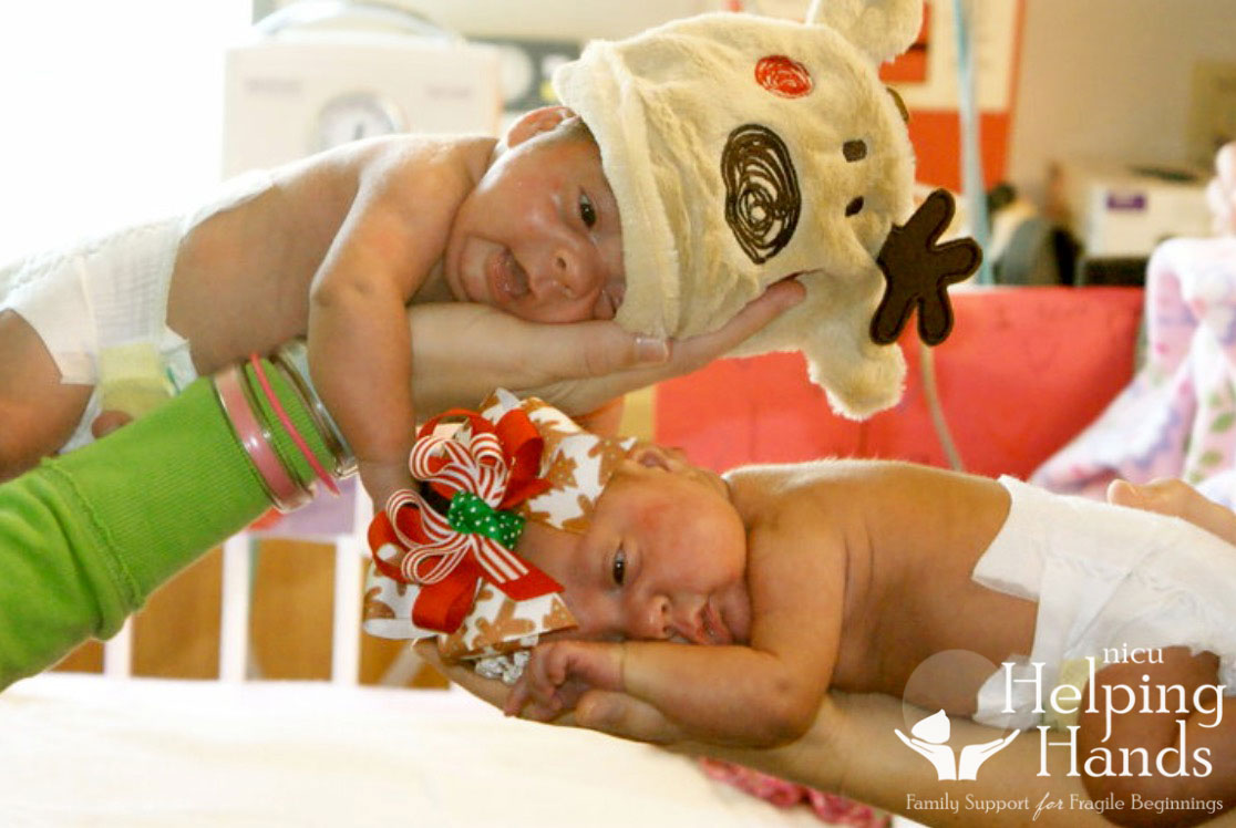 Two newborns in the NICU wearing special holiday outfits.
